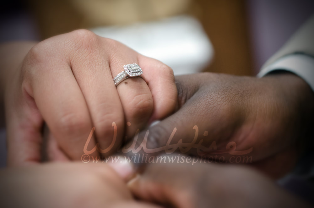 Interracial couple holding hands a the wedding altar Picture